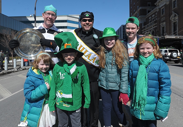 Father Dave Richards is all smiles as he stands with his nieces and nephews and his brother in law during the City of Buffalo Annual St. Patrick's Day Parade on Delaware Avenue. (Dan Cappellazzo/Staff Photographer)